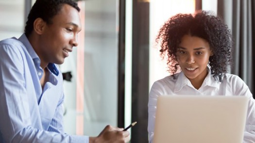A male work and his female manager looking at a computer